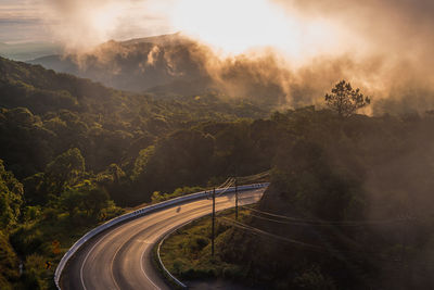 Panoramic view of road amidst trees against sky