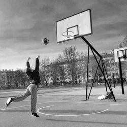 Man playing with basketball hoop