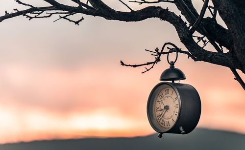 Low angle view of clock tower against sky at sunset