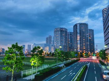 View of city buildings against cloudy sky