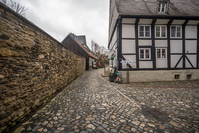 Footpath amidst buildings in city