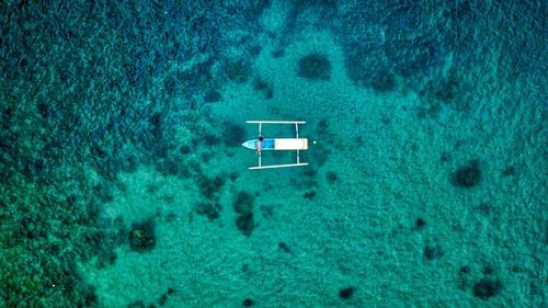 Aerial view of outrigger in sea