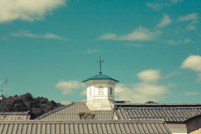 Low angle view of building against cloudy sky