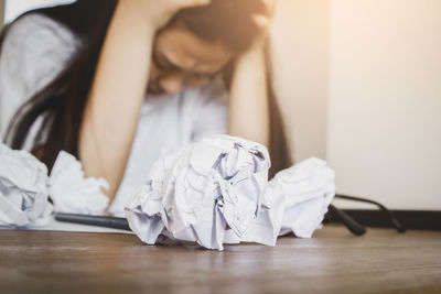Midsection of man sitting on table