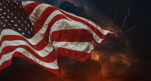 Low angle view of flag against sky during sunset