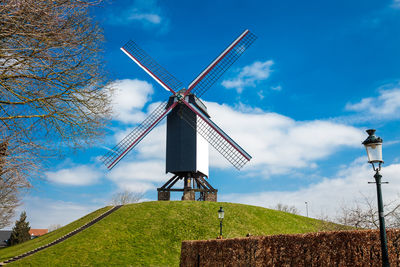 Windmill under a beautiful blue winter sky just before spring at the historical bruges town