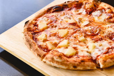 Close-up of pizza on cutting board