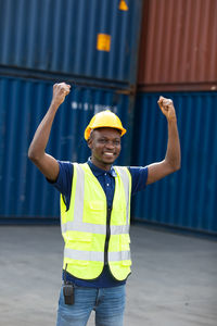 Portrait of a smiling young man standing on field