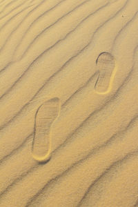 High angle view of heart shape on sand