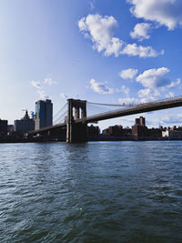 Bridge over river with city in background