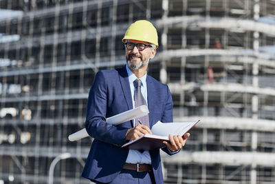 Man wearing hat standing at construction site