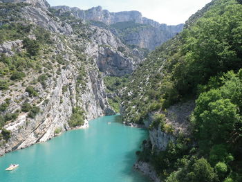 High angle view of river amidst trees against sky