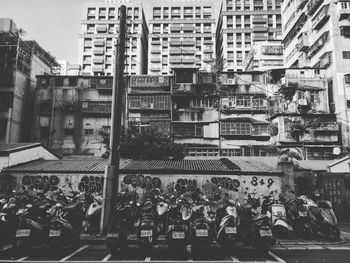 People on street against buildings in city