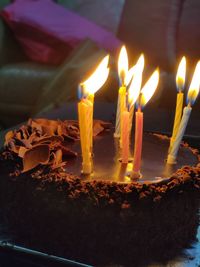 Close-up of burning candles on birthday cake