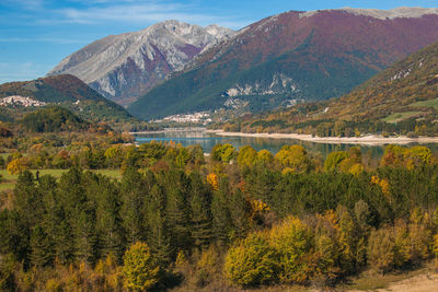 Scenic view of lake and mountains against sky