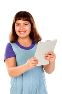 Portrait of smiling teenage girl standing against white background