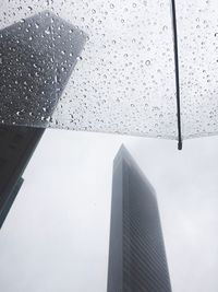Low angle view of raindrops on window