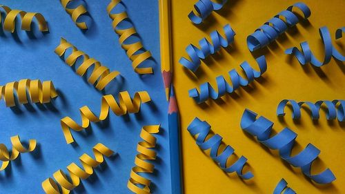 Directly above shot of pencils amidst colorful spiral papers on table