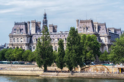 Paris hotel de ville main city hall in paris viewed across the seine river. famous landmark in paris