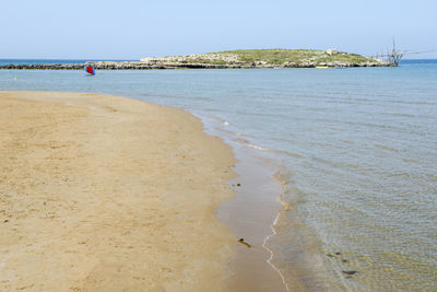 Scenic view of beach against clear sky