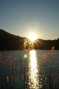Scenic view of lake against sky during sunset