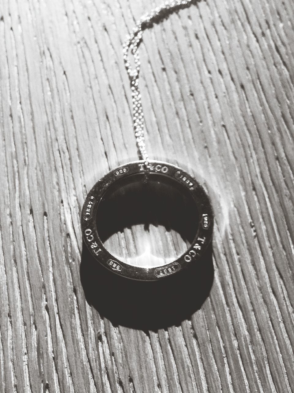 wood - material, close-up, no people, circle, jewelry, day, geometric shape, metal, shape, still life, table, pattern, food and drink, ring, outdoors, hole, high angle view, full frame, nature, textured