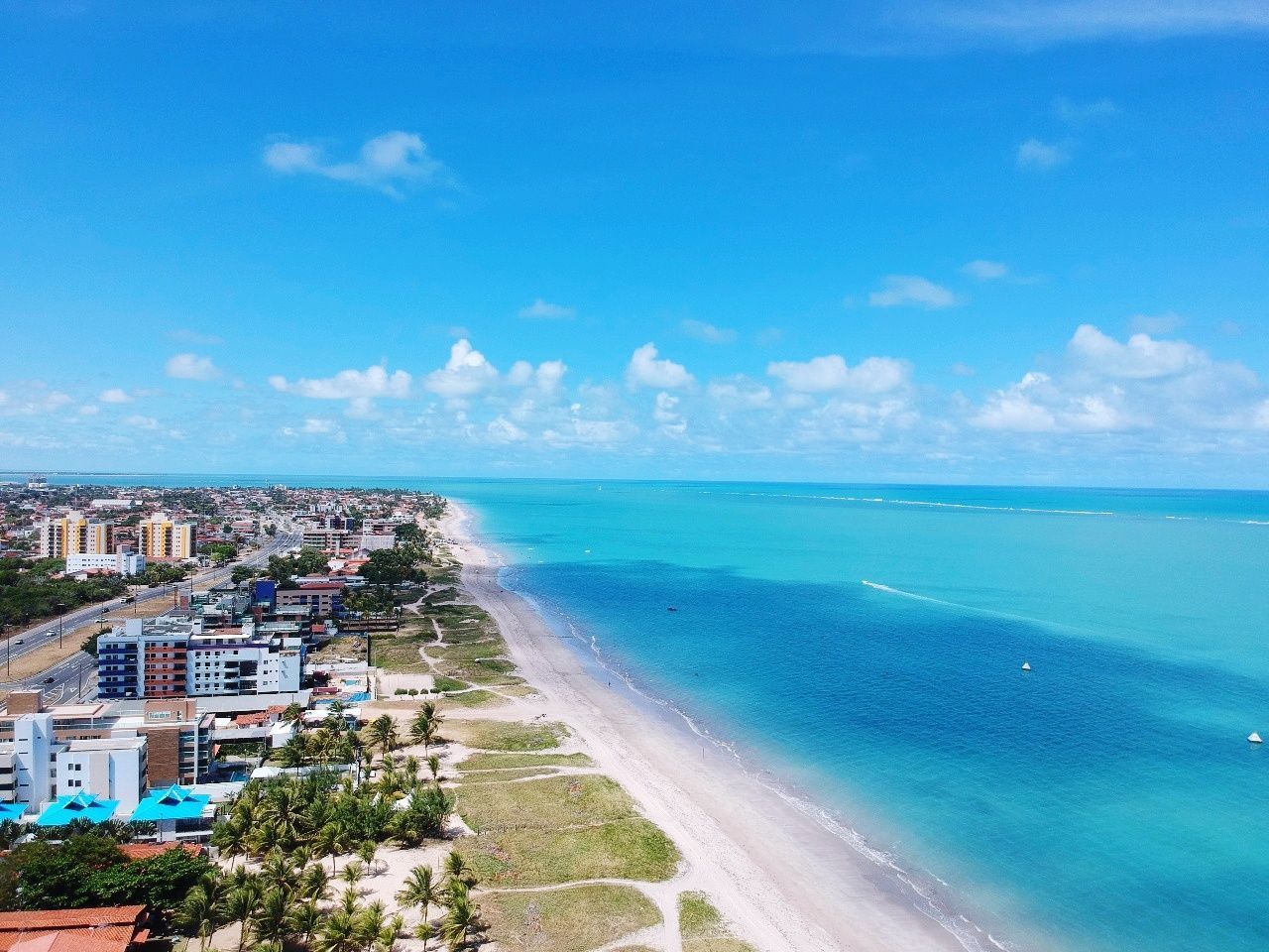 SCENIC VIEW OF BEACH AGAINST BLUE SKY