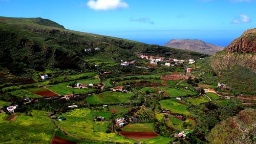 High angle view of green landscape against sky