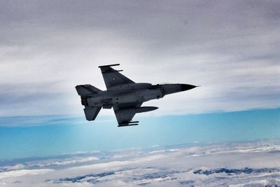 Low angle view of airplane flying in sky