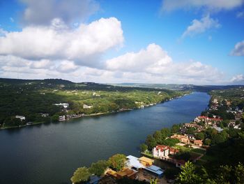 High angle view of townscape by river against sky