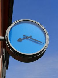 Low angle view of airplane against clear blue sky