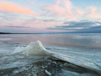 Scenic view of frozen sea against sky during sunset