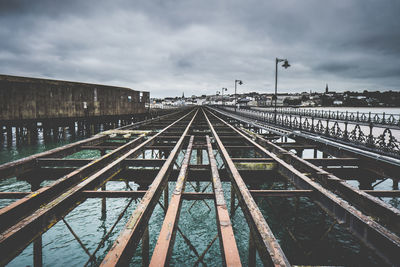 View of railroad tracks against cloudy sky