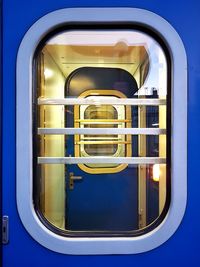 Close-up of yellow window against blue sky