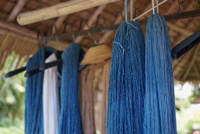 Close-up of threads hanging in store for sale