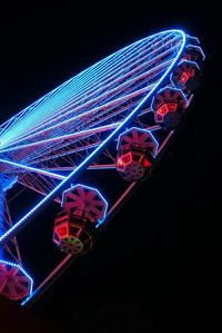 Low angle view of light trails against sky at night