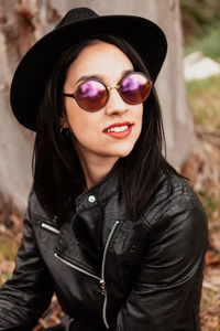 Close-up of woman wearing sunglasses standing outdoors