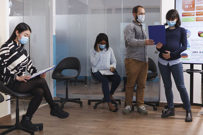 Business colleagues wearing mask working at office