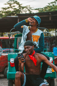 Hip hop styled young adults looking to at their smartphone in a garage