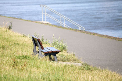 Chair on bench by sea shore