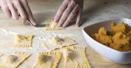 Cropped image of woman preparing food on table