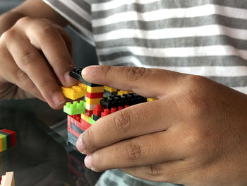Close-up of boy playing with toy blocks at home