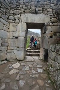 People walking on stone wall