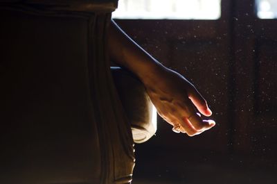 Close-up of hand on sofa at home