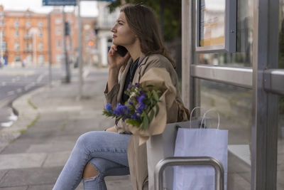 Side view of woman looking at camera