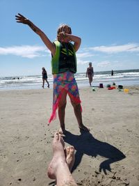 People on beach against sky