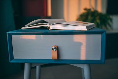 Close-up of open book on table at home