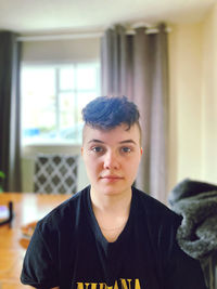 Portrait of teenage boy sitting at home