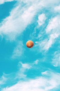 Low angle view of hot air balloon against cloudy sky