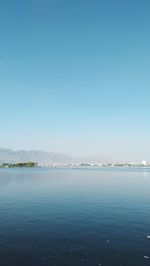 Scenic view of sea against clear blue sky